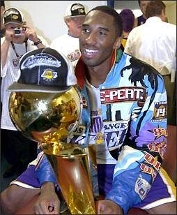 Kobe Holds The Championship Trophy